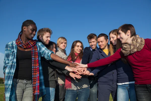 Happy College Students with Hands on Stack — Stock Photo, Image