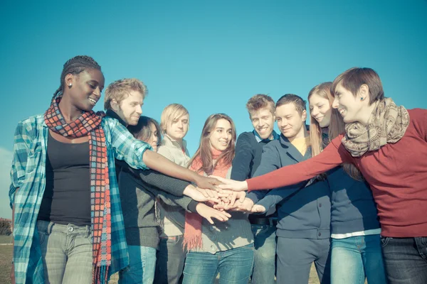 Happy College Studenti con le mani sulla pila — Foto Stock