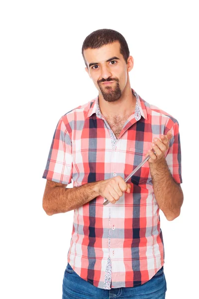 Vážný muž drží v rukou klíč — Stock fotografie
