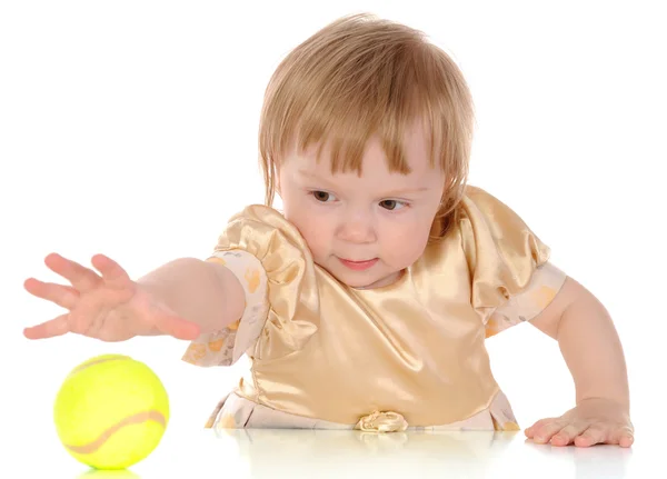 Little girl and tennis ball. — Stock Photo, Image