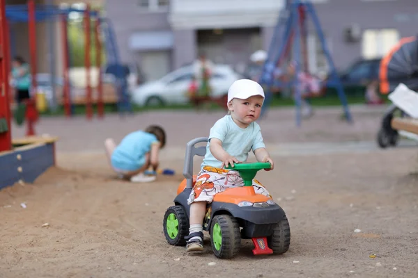 Little boy drives toy ATV — Stock Photo, Image
