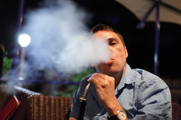 Homem fuma shisha — Fotografia de Stock