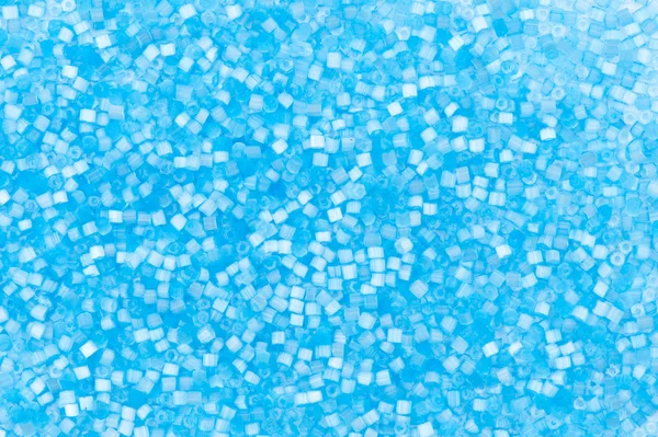 Hintergrund aus blauen dekorativen Kunststoff-Bastelperlen — Stockfoto