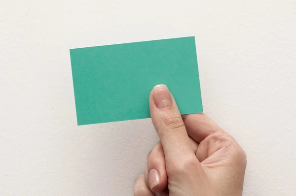 Business card in hand on white background — Stock Photo, Image