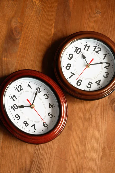 Pair Of Clocks On Wood — Stock Photo, Image