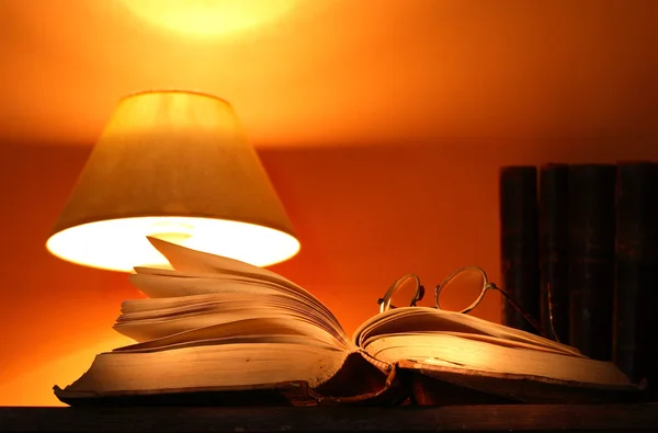 Skrivbordslampa och gamla böcker — Stockfoto