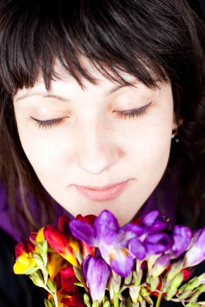Vrouw met rode en paarse bloemen — Stockfoto