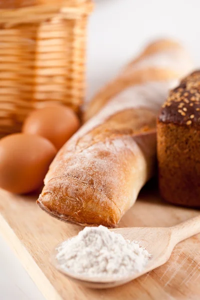 Pão, farinha, ovos e utensílio de cozinha — Fotografia de Stock