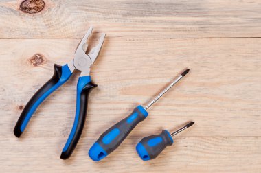 Construction tools on a wooden board. clipart