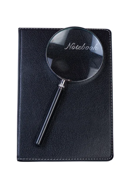 Notebook with magnifying glass on white isolate. — Stock Photo, Image