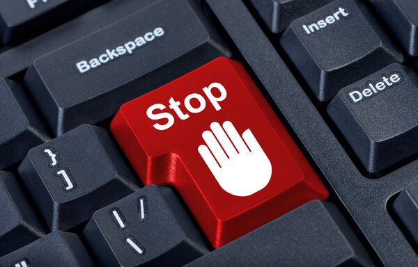 Button stop computer keyboard with hand icon.