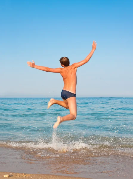 stock image Boy jumping on beach.