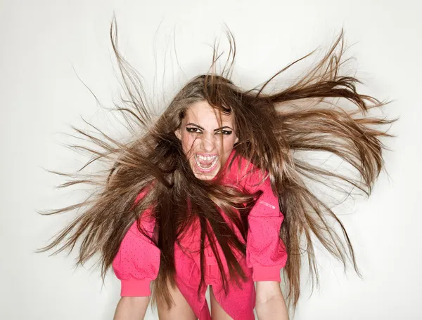Screaming furious aggressive brunette lady with flying long hair — Stock Photo, Image