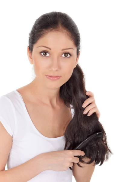 Young brunette beautiful woman combing long hairs — Stock Photo, Image