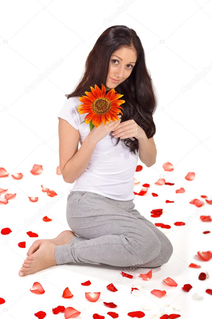 Young beautiful lady holding sunflower near face