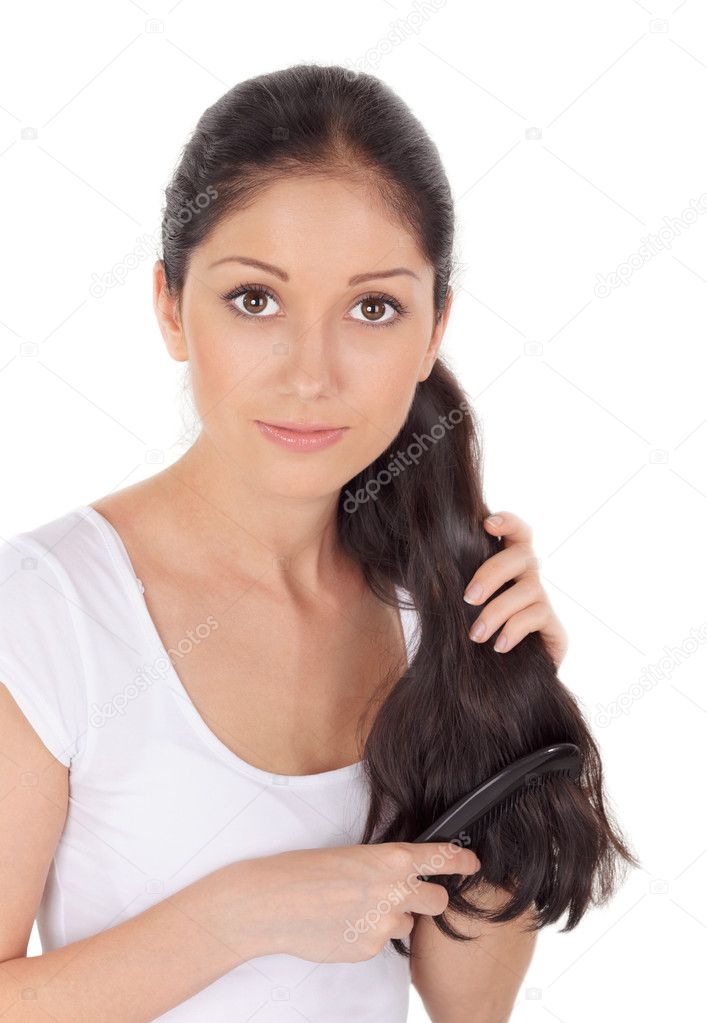 Young brunette beautiful woman combing long hairs
