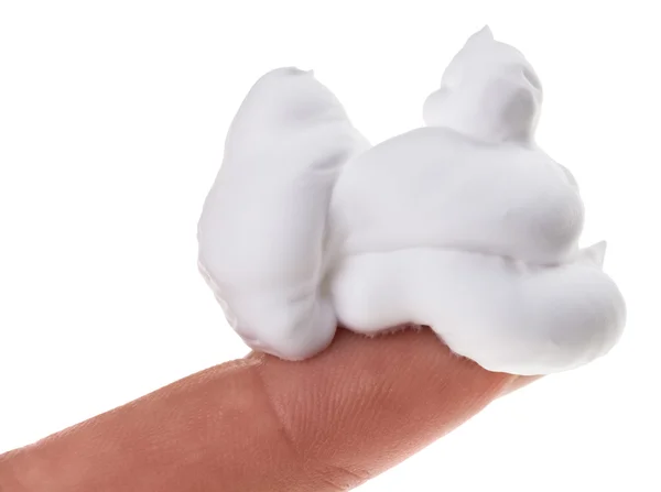 Muestra de espuma de afeitar (crema) en el dedo índice, aislada en blanco —  Fotos de Stock