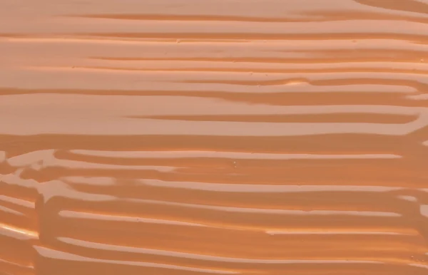 Бежевый тон крем (фундамент) макияж, текстура фона — стоковое фото