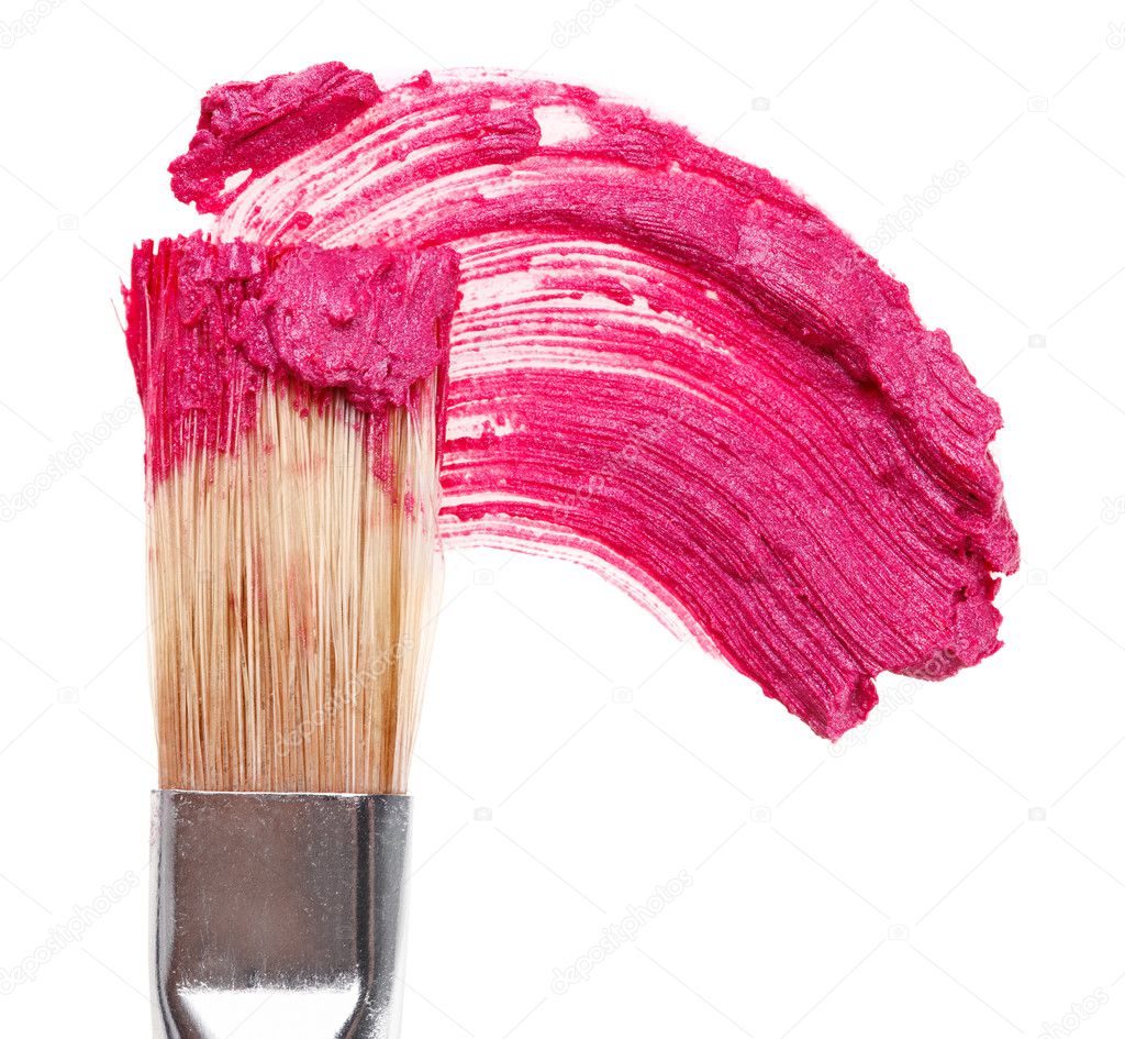 Pink lipstick stroke (sample) with makeup brush, isolated on whi