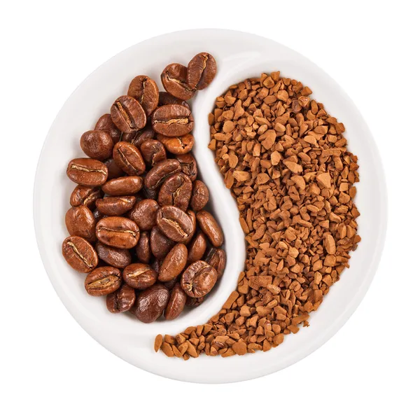 stock image Natural coffee beans versus instant one in Yin Yang shaped plate