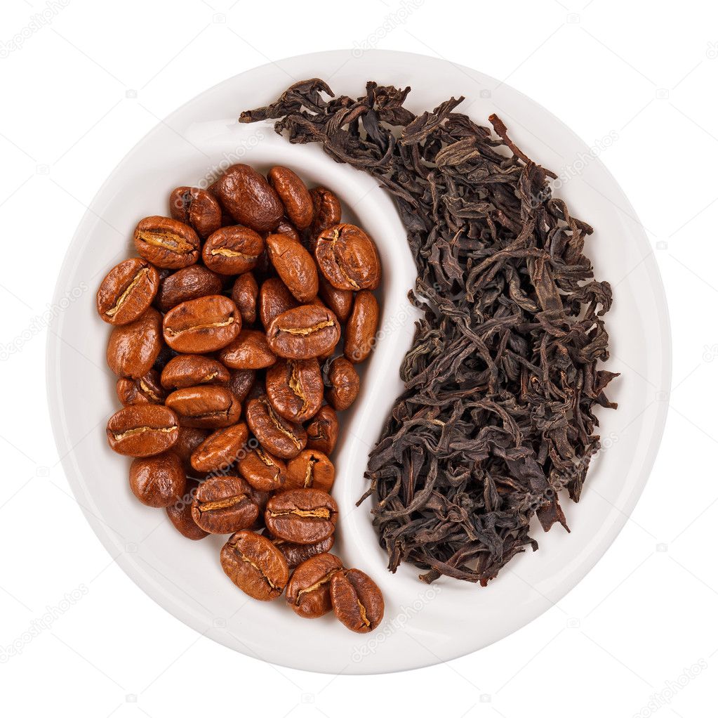 Black leaf tea versus coffee beans in Yin Yang shaped plate, iso