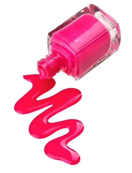 Бутылка розового лака для ногтей с образцами капель эмали, выделенных на — стоковое фото