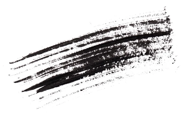Carrera (muestra) de rímel negro, aislado en macro blanco — Foto de Stock
