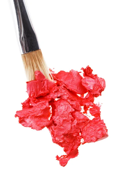Red lipstick stroke (sample) with makeup brush, isolated on whit — Stock Photo, Image