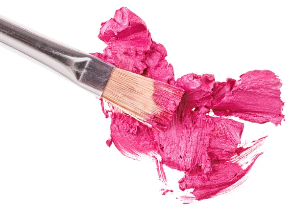 Pincelada de labios rosa (muestra) con pincel de maquillaje, aislado en whi —  Fotos de Stock