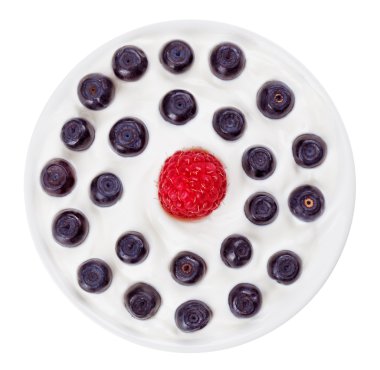 Red raspberry and blue bilberry in small round plate with sour c clipart