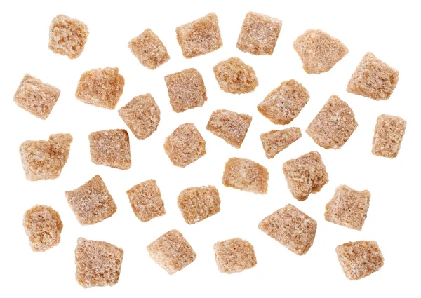 Viele braune Rohrzuckerwürfel isoliert auf weißem, Lebensmittelbackgro — Stockfoto