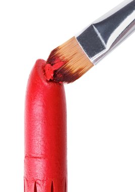 Makeup brush pushed in on red lipstick, isolated on white clipart