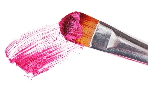 Pink lipstick stroke (sample) with makeup brush, isolated on whi — Stock Photo, Image