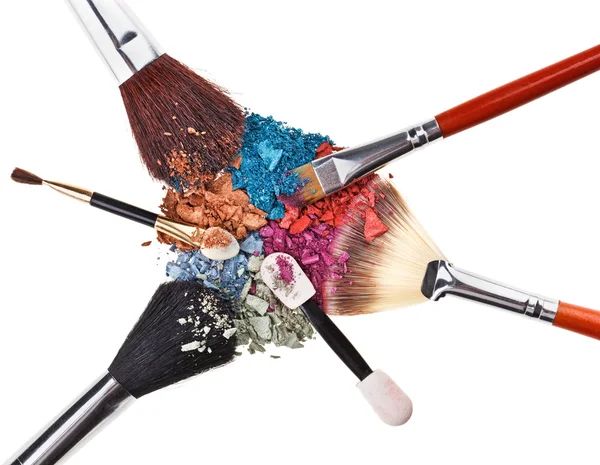 Composition with makeup brushes and broken multicolor eye shadow — Stock Photo, Image