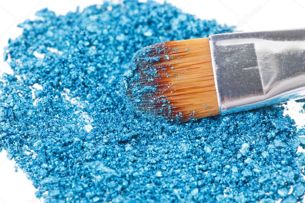 Makeup brush with blue crushed eye shadow