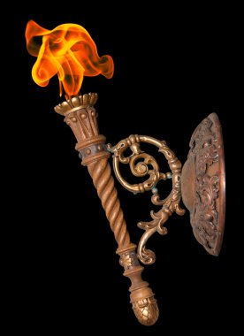 Old torch on black background clipart