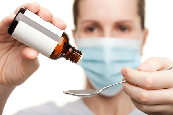 Doctor in mask holding medicine syrup — Stock Photo, Image