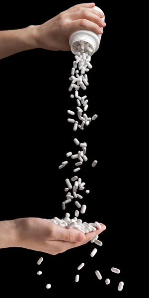 Derramando pílulas de vitaminas — Fotografia de Stock