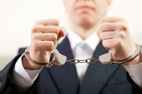 Handcuffs on hands — Stock Photo, Image