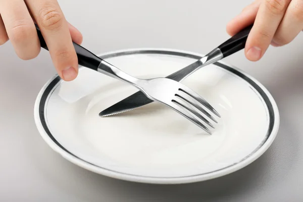 Hand holding fork and knife — Stock Photo, Image