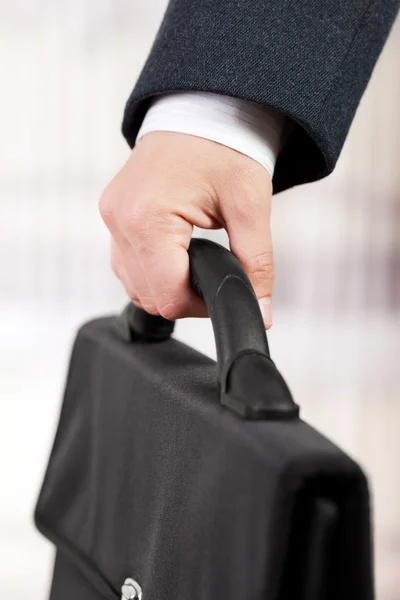 Hand holding briefcase — Stock Photo, Image