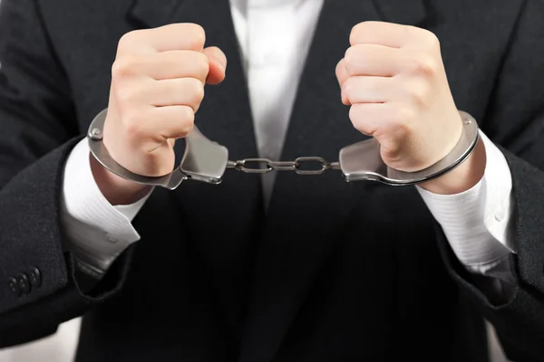 Handcuffs on hands — Stock Photo, Image