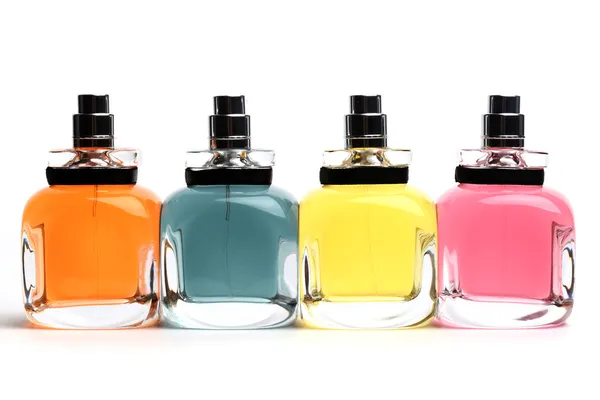 Vier farbige Parfümflaschen lizenzfreie Stockfotos