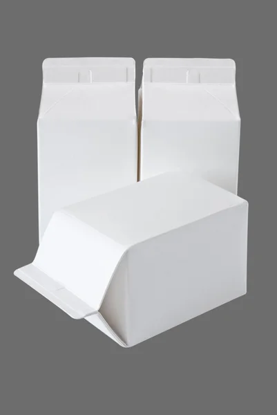 Tres cajas de leche por medio litro en gris —  Fotos de Stock
