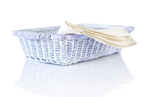 Wicker basket and napkin on white — Stock Photo, Image