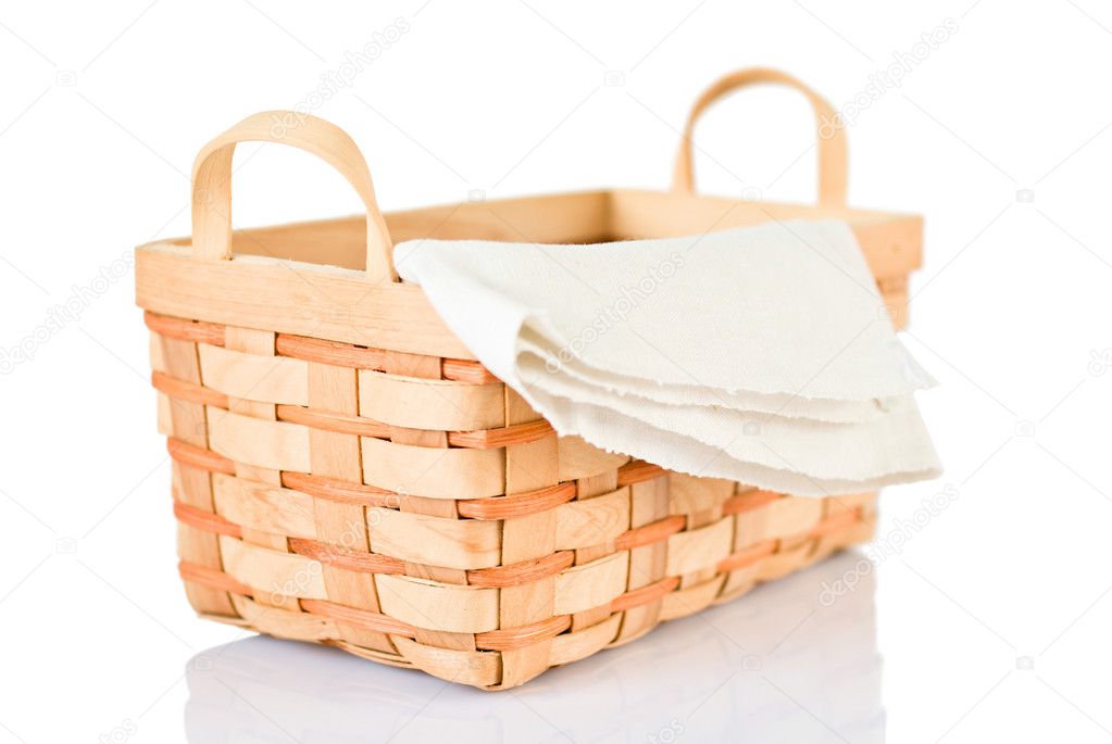Wicker basket and napkin on white