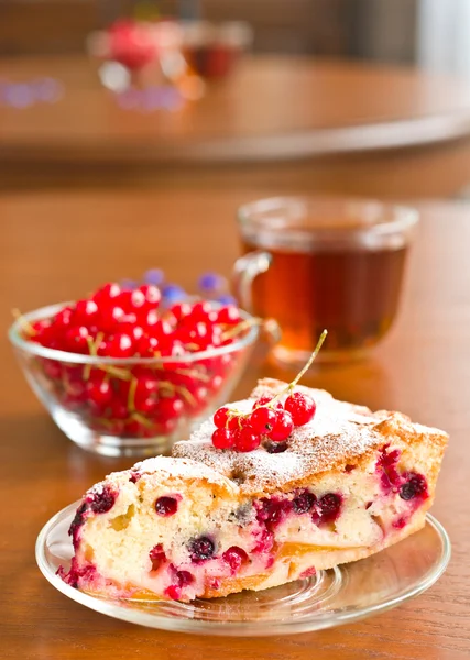 Piece of berry pie on saucer and red currants — Stock Photo, Image