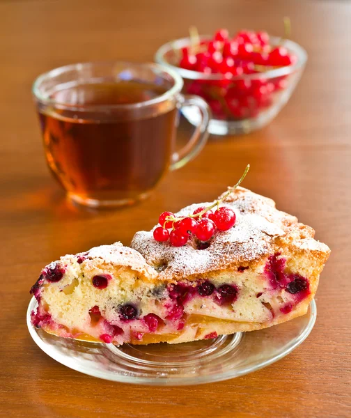 Piece of berry pie on saucer and red currants — Stock Photo, Image