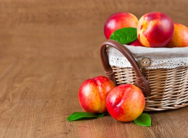 Juicy nectarines in the basket clipart