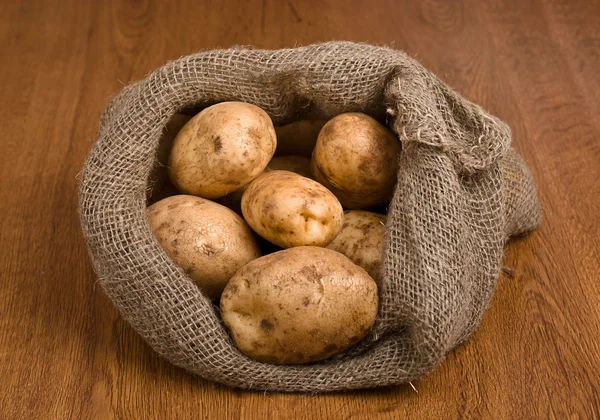 Cosecha de patatas en saco de arpillera — Foto de Stock